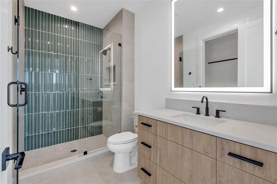 Bathroom with vanity, a stall shower, recessed lighting, and tile patterned flooring Bathroom with vanity, a stall shower, recessed lighting, and tile patterned flooring