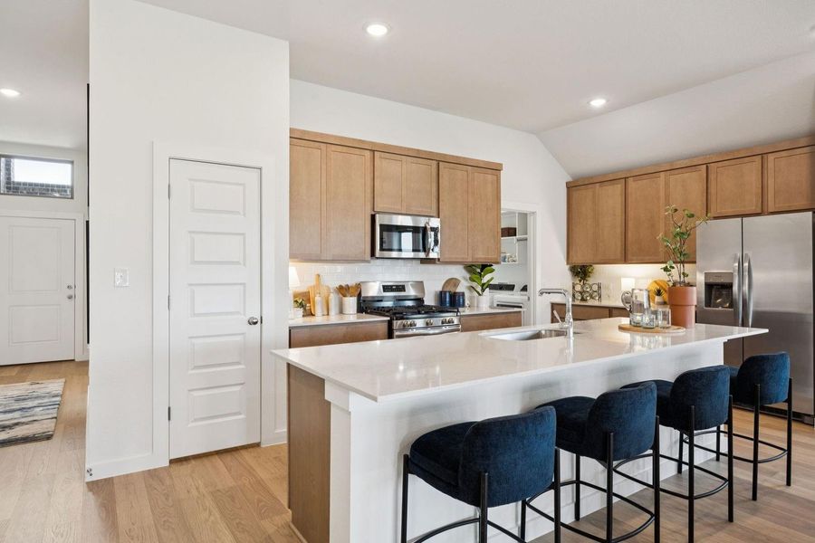 Kitchen in the Diamond home plan by Trophy Signature Homes – REPRESENTATIVE PHOTO
