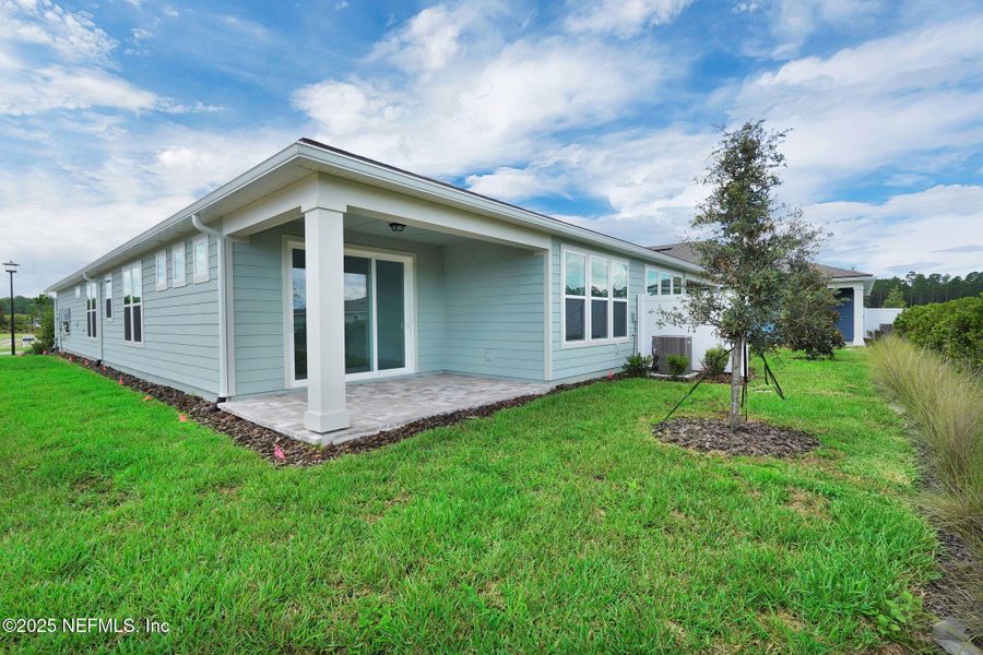 Front exterior of a new home in Del Webb Wildlight, Yulee, FL, highlighting curb appeal (Image 20).