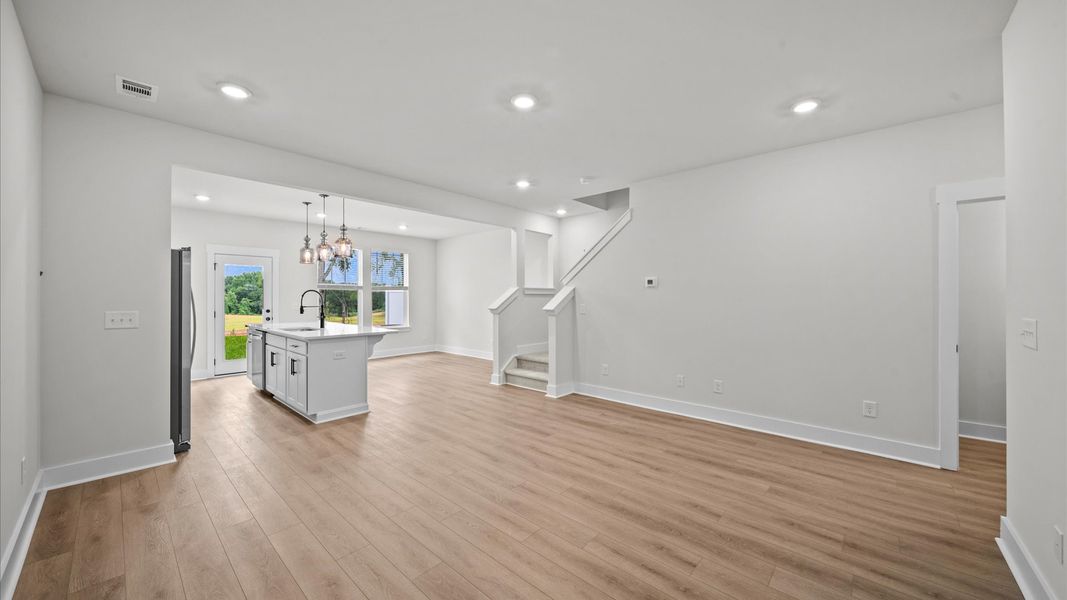 Open concept, hardwood flooring family room in two story townhome at Ransdell Pointe by DRB Homes in Spartanburg, SC Open concept, hardwood flooring family room in two story townhome at Ransdell Pointe by DRB Homes in Spartanburg, SC