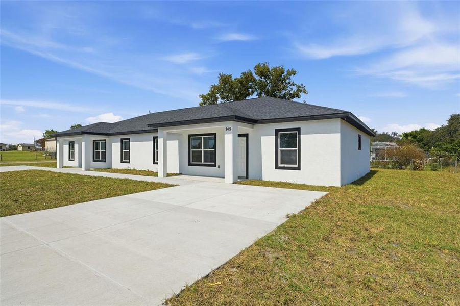 Front exterior of a new home in , Haines City, FL, highlighting curb appeal (Image 26).
