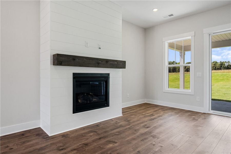 A striking fireplace with a shiplap facade and rus
