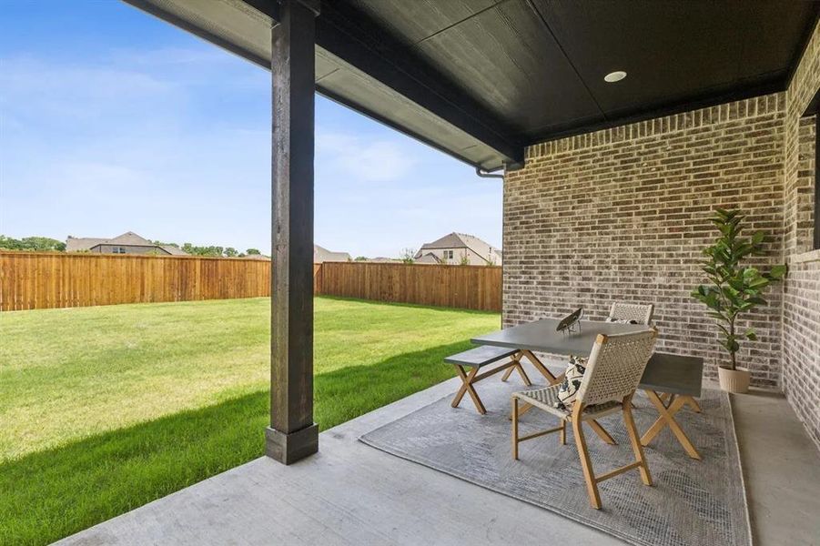 Fenced backyard featuring a patio and outdoor dining area