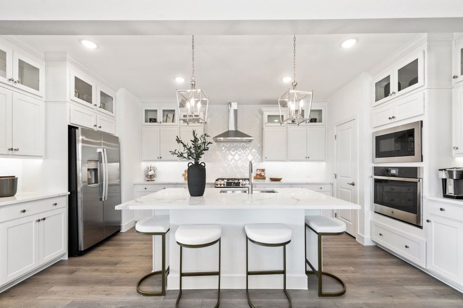 Kitchen with glass upper cabinets and pendant lighting