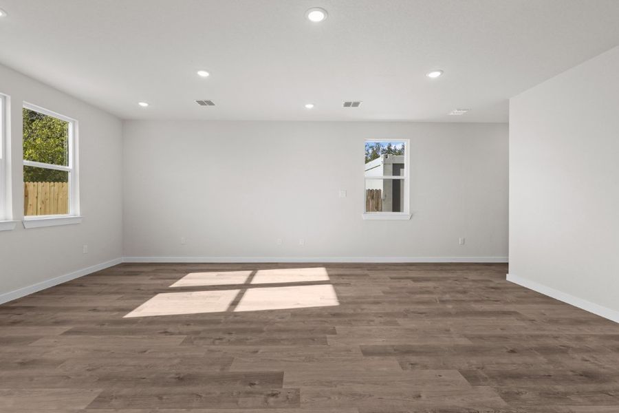 A room with a wood floor and windows. A room with a wood floor and windows.