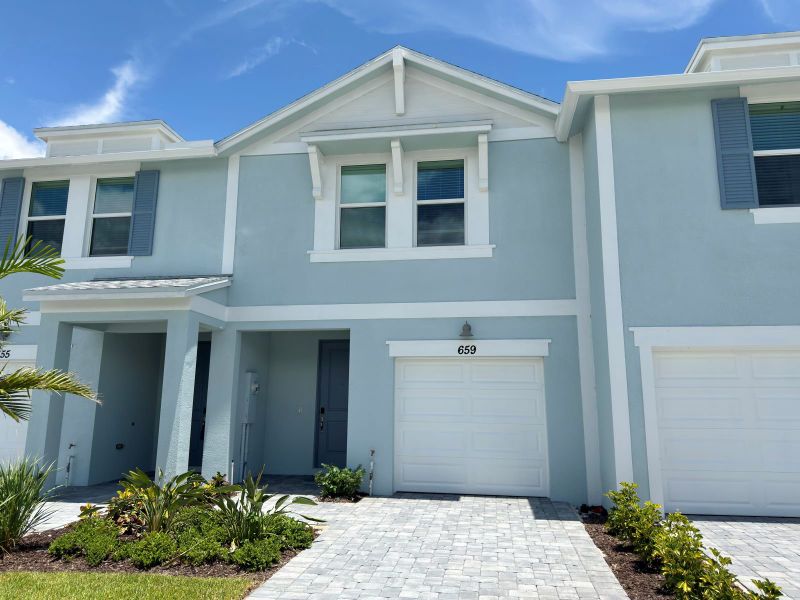 Front exterior of a new home in Tidewater, Fort Pierce, FL, highlighting curb appeal (Image 2). Front exterior of a new home in Tidewater, Fort Pierce, FL, highlighting curb appeal (Image 2).