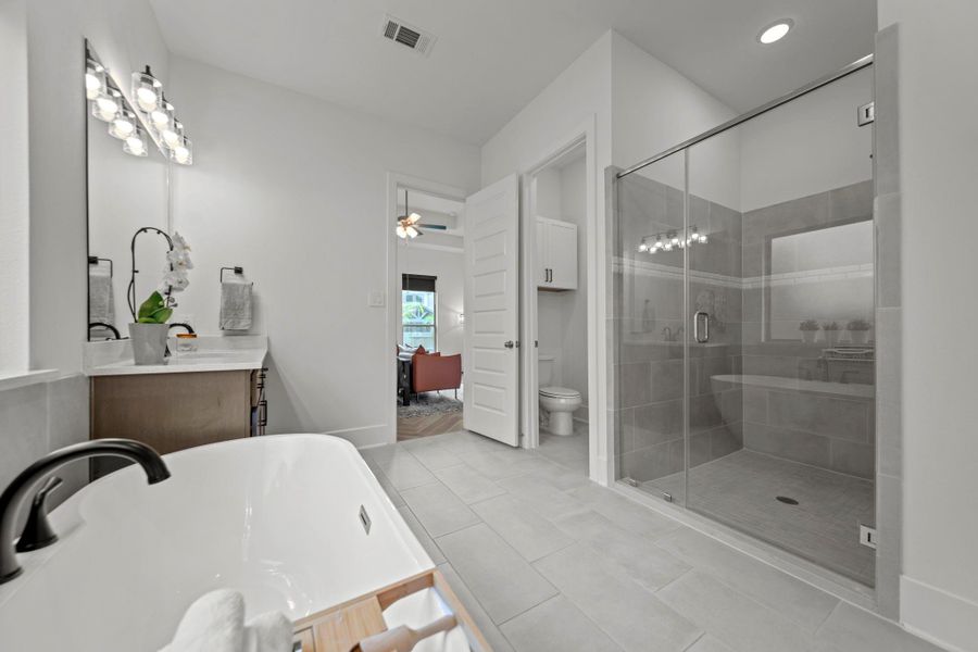 Primary bath offers a spacious layout with glass shower, dual sinks, and a clear view back into the suite. Primary bath offers a spacious layout with glass shower, dual sinks, and a clear view back into the suite.