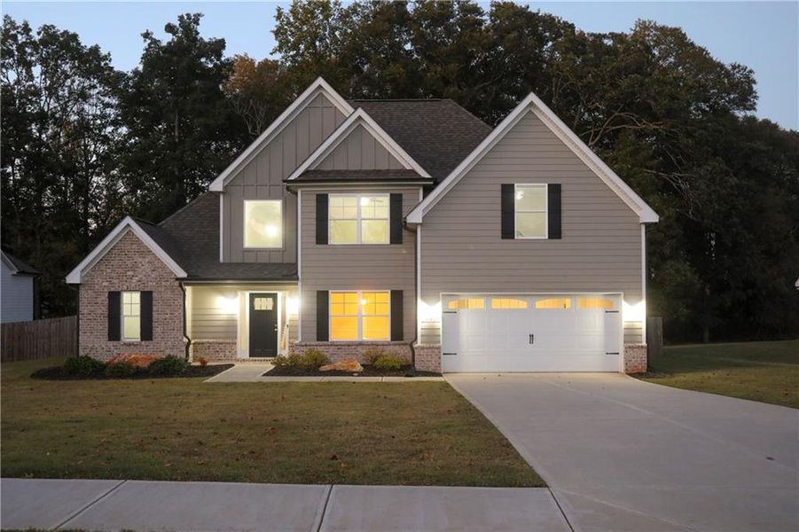 Front exterior of a new home in , Winder, GA, highlighting curb appeal (Image 1). Front exterior of a new home in , Winder, GA, highlighting curb appeal (Image 1).