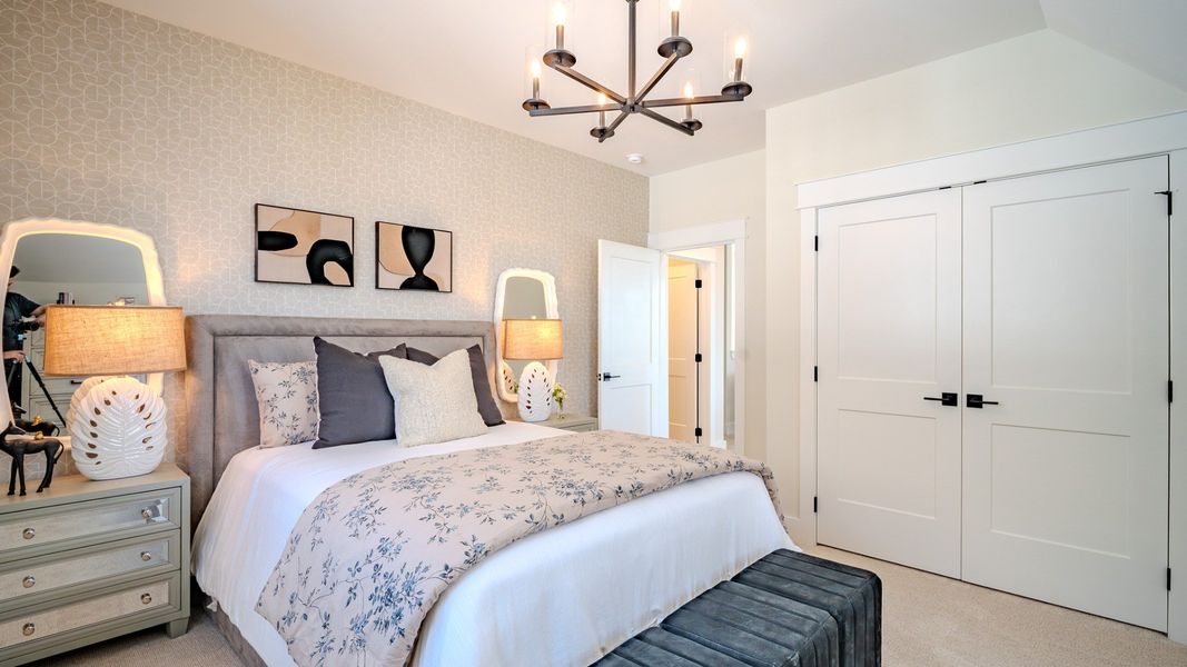 Secondary bedroom with carpet and bright natural light from windows