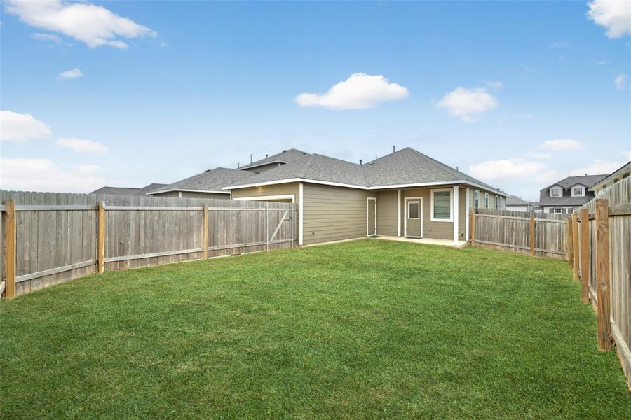 Rear view of property with a shingled roof, a patio, and a fenced backyard Rear view of property with a shingled roof, a patio, and a fenced backyard