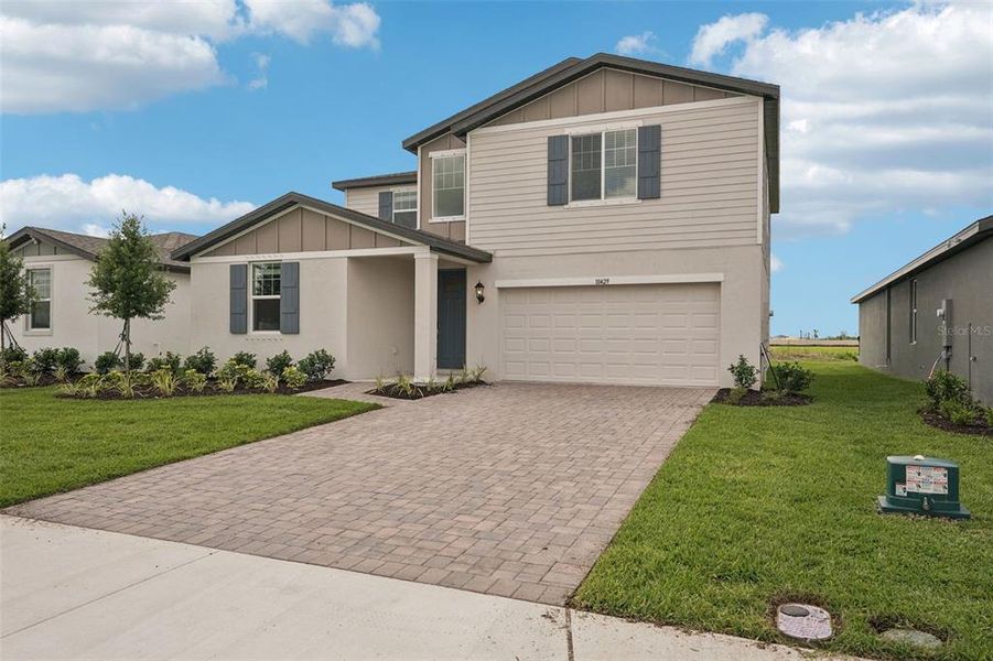 Front exterior of a new home in Oakfield Trails - Classic Series, Parrish, FL, highlighting curb appeal (Image 20). Front exterior of a new home in Oakfield Trails - Classic Series, Parrish, FL, highlighting curb appeal (Image 20).