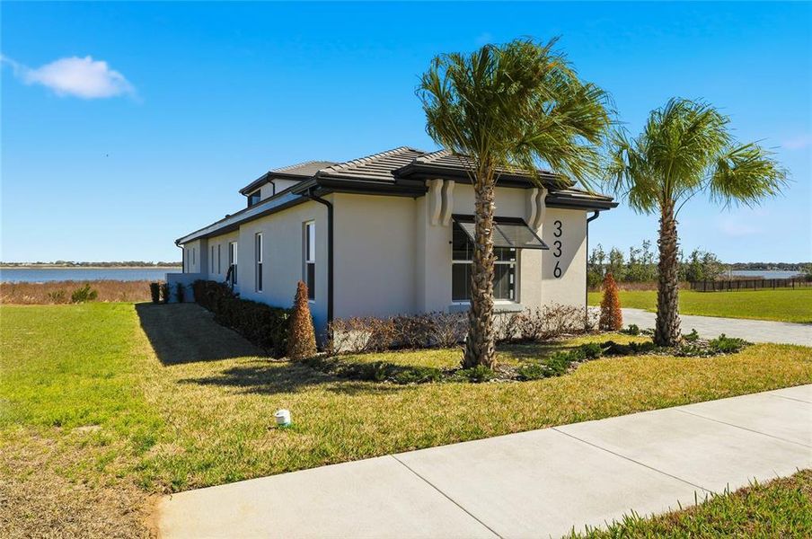 Front exterior of a new home in , Lake Alfred, FL, highlighting curb appeal (Image 27). Front exterior of a new home in , Lake Alfred, FL, highlighting curb appeal (Image 27).