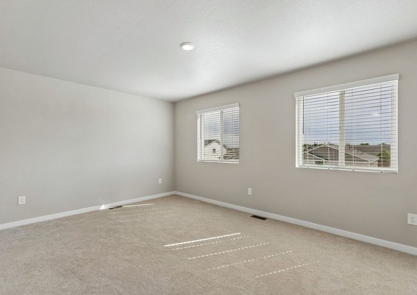 The master bedroom is spacious with large windows.