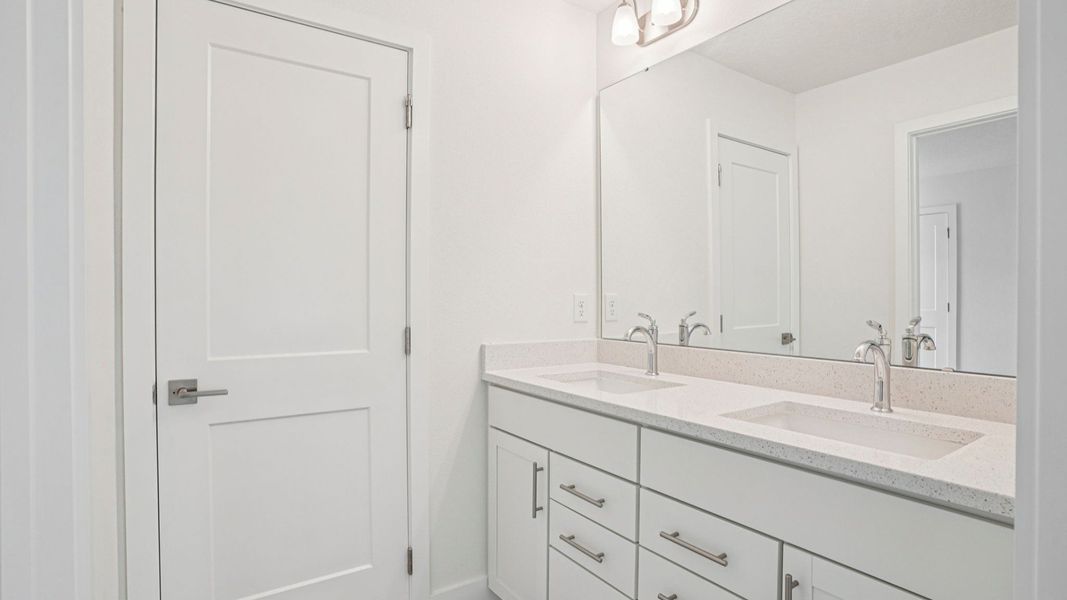 Walk-in shower with glass enclosure and tile in the Plumeria plan at Lakeside at Satilla by DRB Homes. Walk-in shower with glass enclosure and tile in the Plumeria plan at Lakeside at Satilla by DRB Homes.