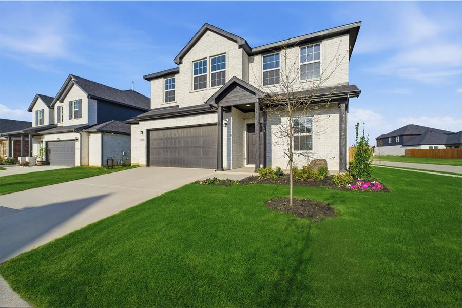 Front exterior of a new home in Sagebrook, Argyle, TX, highlighting curb appeal (Image 2). Front exterior of a new home in Sagebrook, Argyle, TX, highlighting curb appeal (Image 2).