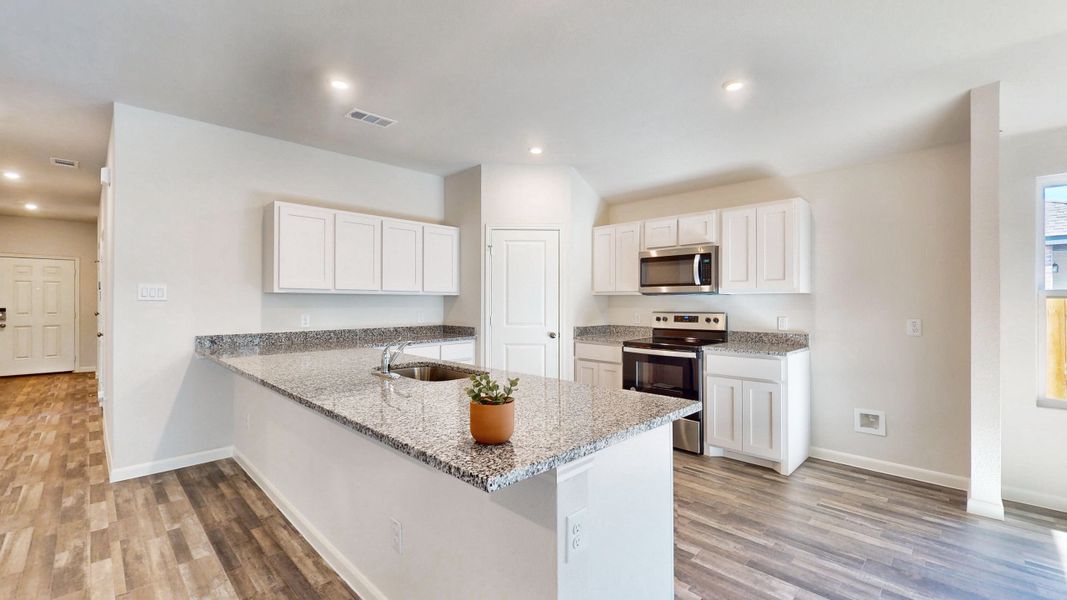 A kitchen with white cabinets. A kitchen with white cabinets.