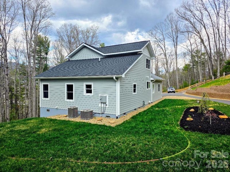 View of the rear and side of 22 Saltbox with dual zone heat pump units