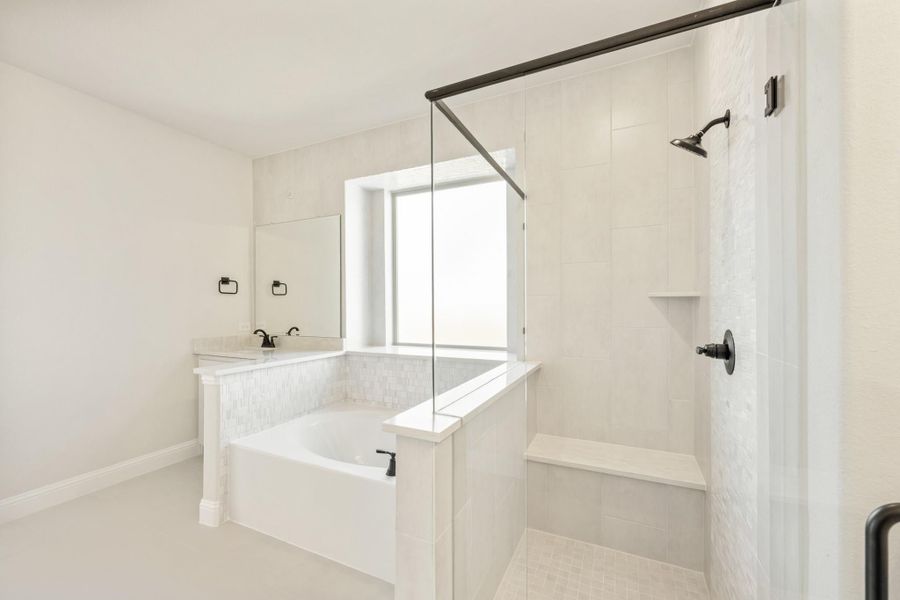 White bathroom with soaking tub, walk-in shower with bench, and black fixtures