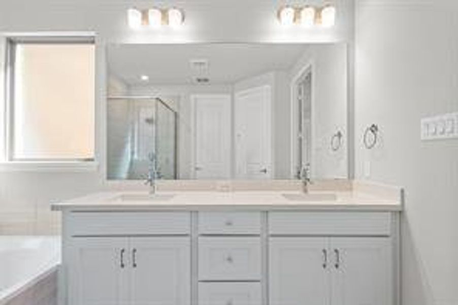 Bathroom featuring plus walk in shower and vanity