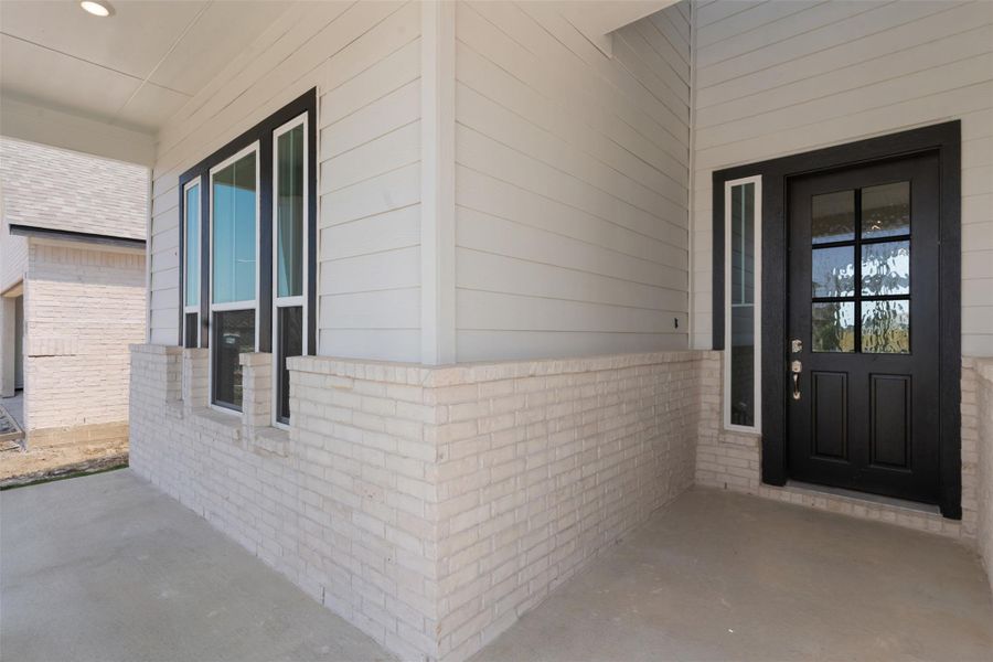 View of exterior entry featuring covered porch and brick siding View of exterior entry featuring covered porch and brick siding