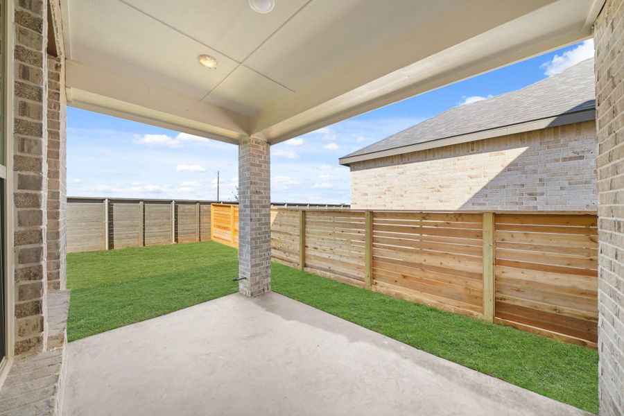 The outdoor covered patio with stately pillars, overlooks the backyard providing a perfect setting for outdoor relaxation and entertaining. The outdoor covered patio with stately pillars, overlooks the backyard providing a perfect setting for outdoor relaxation and entertaining.