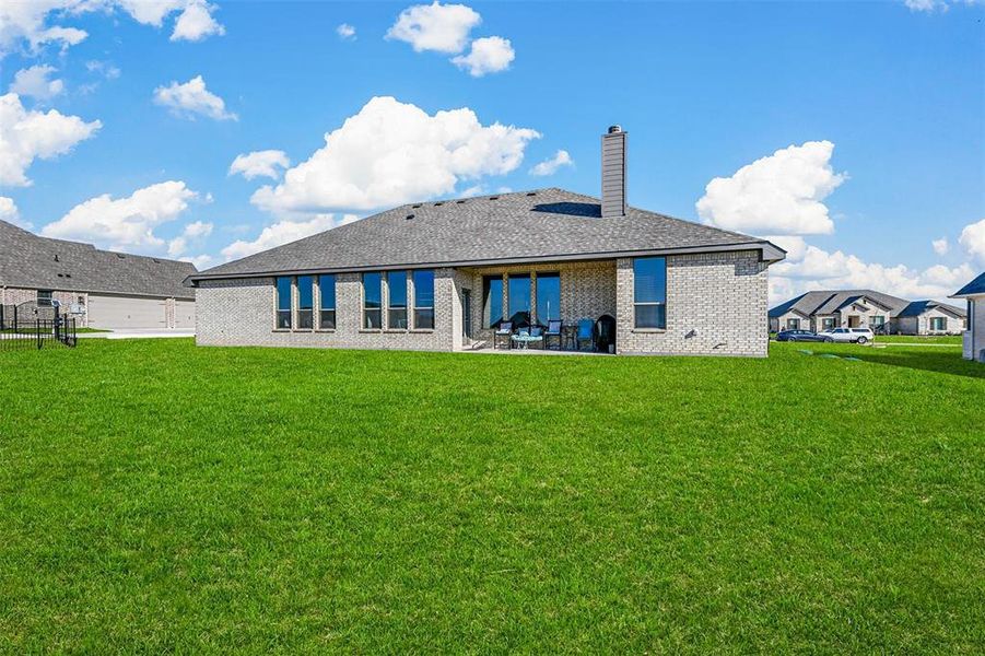 Back of property featuring a patio area and a yard