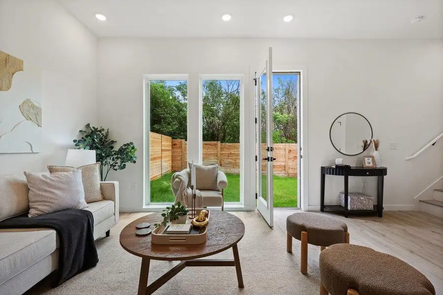 Living area with light wood flooring and a light-colored rug