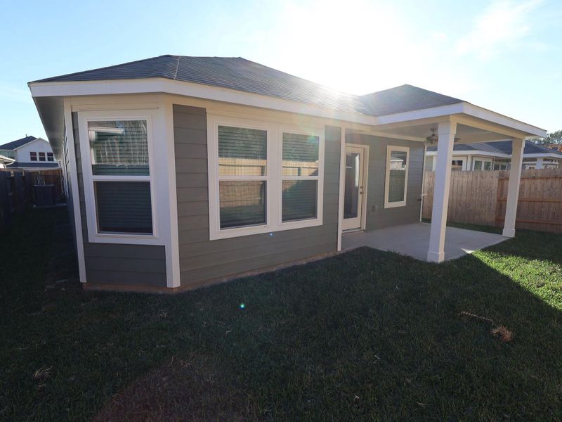 Exterior details and patio area of a home in Pinewood at Grand Texas, New Caney (Image 27).