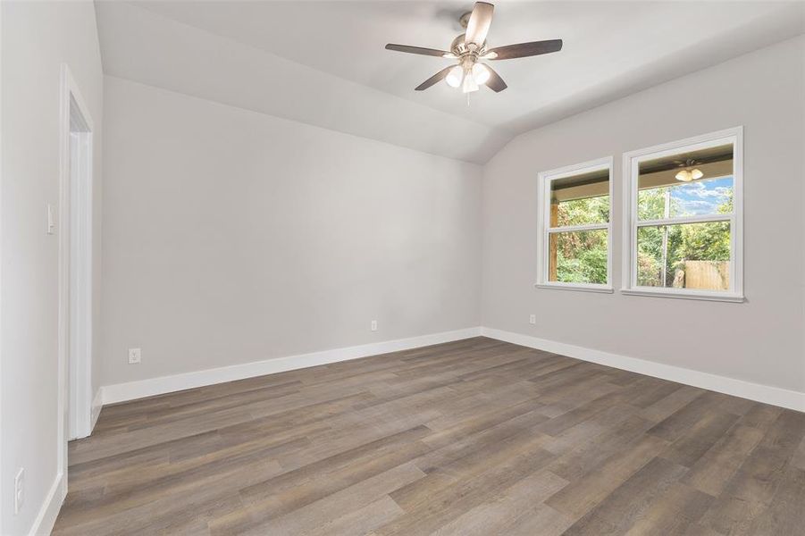 Unfurnished room with ceiling fan, wood-type flooring, and lofted ceiling