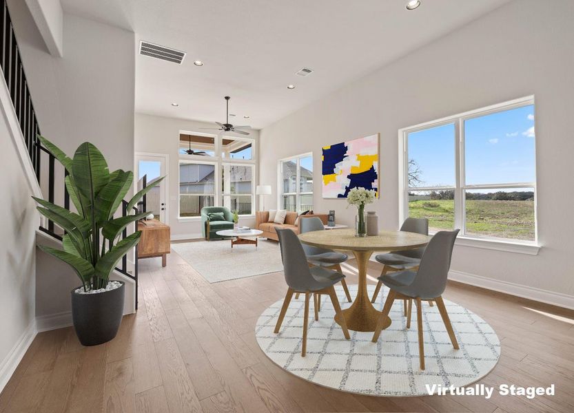 Dining room featuring a ceiling fan, visible vents, wood finished floors, and baseboards Dining room featuring a ceiling fan, visible vents, wood finished floors, and baseboards