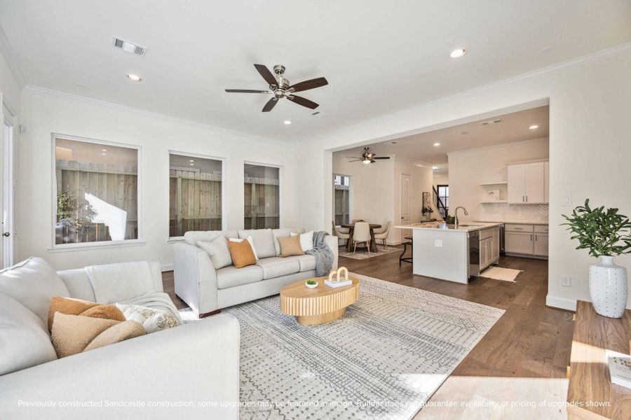 This wide-angle view shows off the magic of first-floor living—kitchen, dining, and living all connected in one beautifully cohesive space.