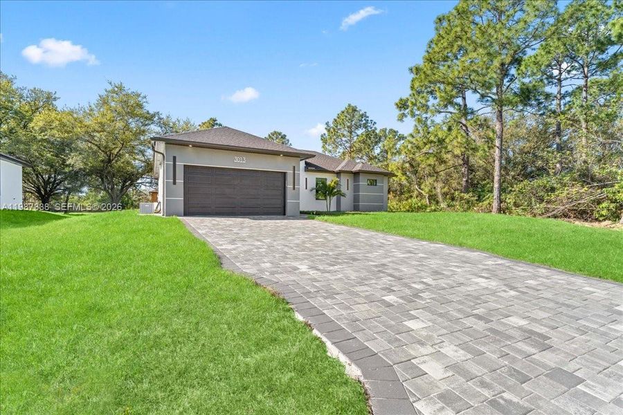 Front exterior of a new home in , Lehigh Acres, FL, highlighting curb appeal (Image 21).