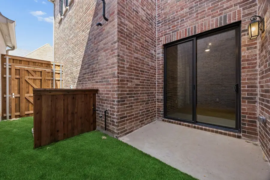 Exterior details and patio area of a home in Newman Village Townhomes, Frisco (Image 19).