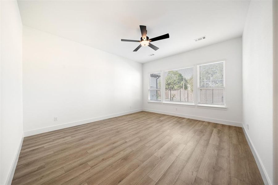 Unfurnished room with light wood finished floors and a ceiling fan