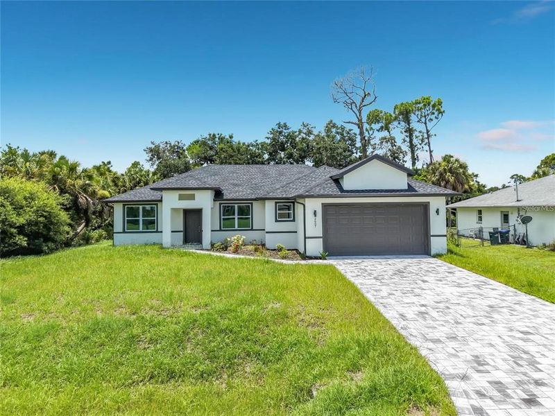 Front exterior of a new home in , North Port, FL, highlighting curb appeal (Image 24).