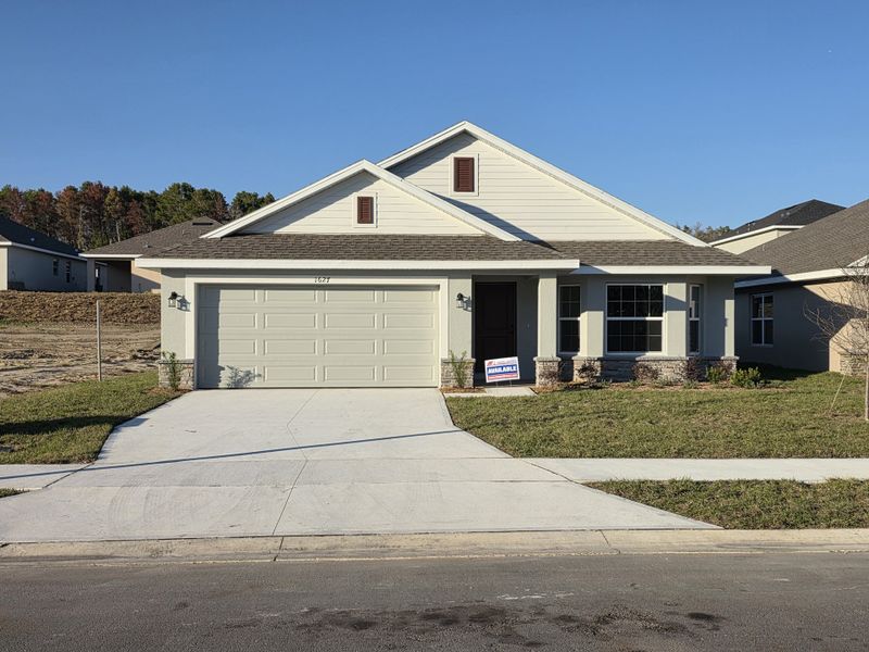 Front exterior of a new home in Arbor Park, Leesburg, FL, highlighting curb appeal (Image 1).