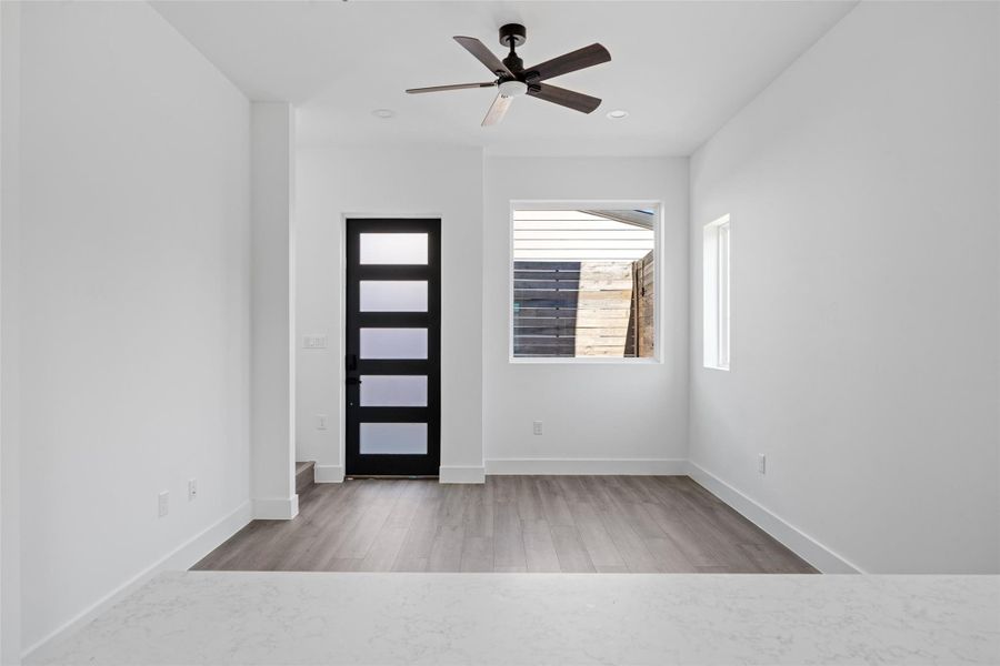 Foyer entrance with light wood finished floors, a ceiling fan, and recessed lighting Foyer entrance with light wood finished floors, a ceiling fan, and recessed lighting