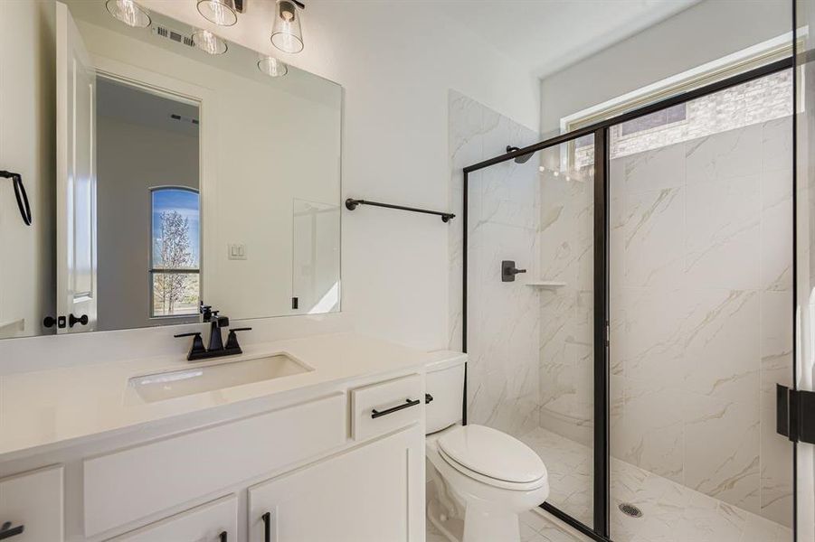 Full bathroom featuring vanity and a marble finish shower