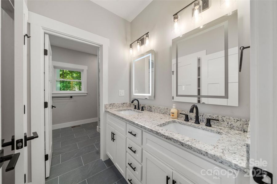 Spacious dual vanities in the ensuite primary bath