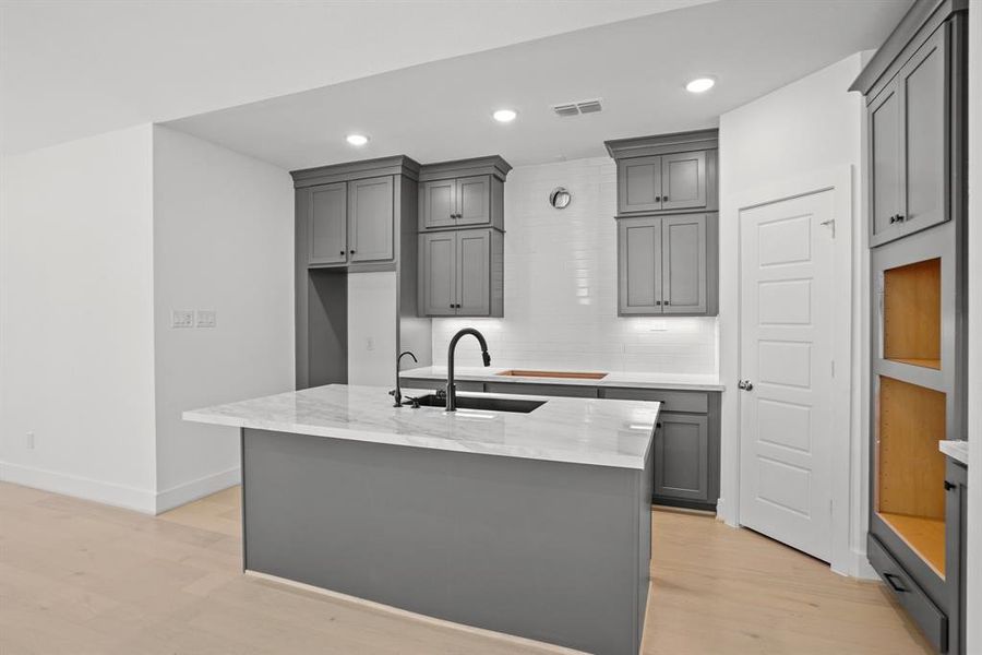 Double stacked cabinets in gourmet kitchen