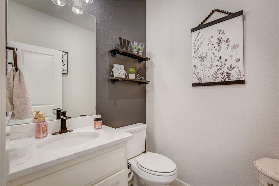 Bathroom featuring vanity and toilet