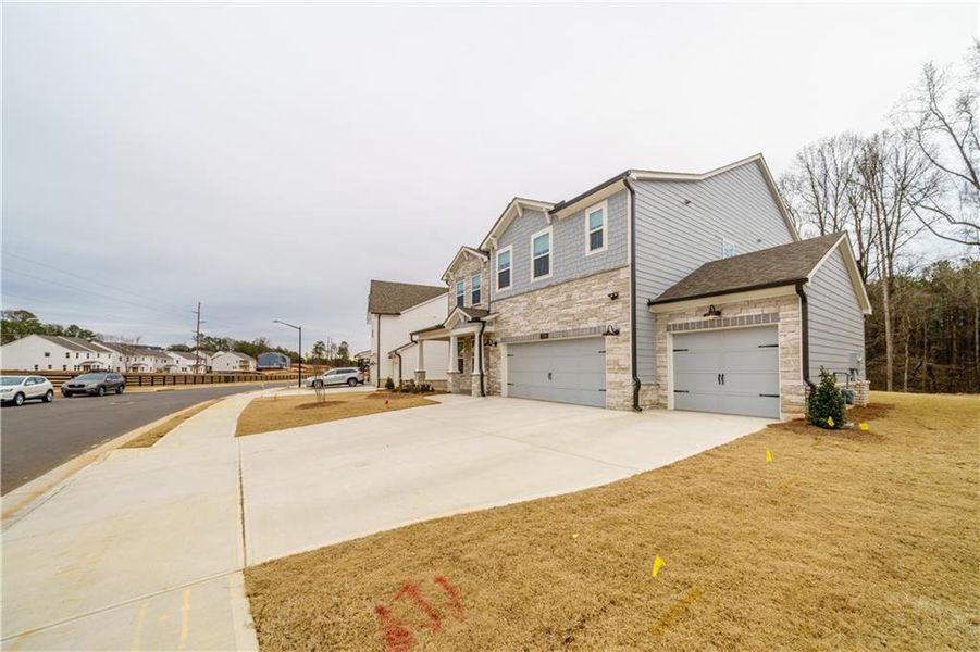 Front exterior of a new home in , Powder Springs, GA, highlighting curb appeal (Image 33). Front exterior of a new home in , Powder Springs, GA, highlighting curb appeal (Image 33).