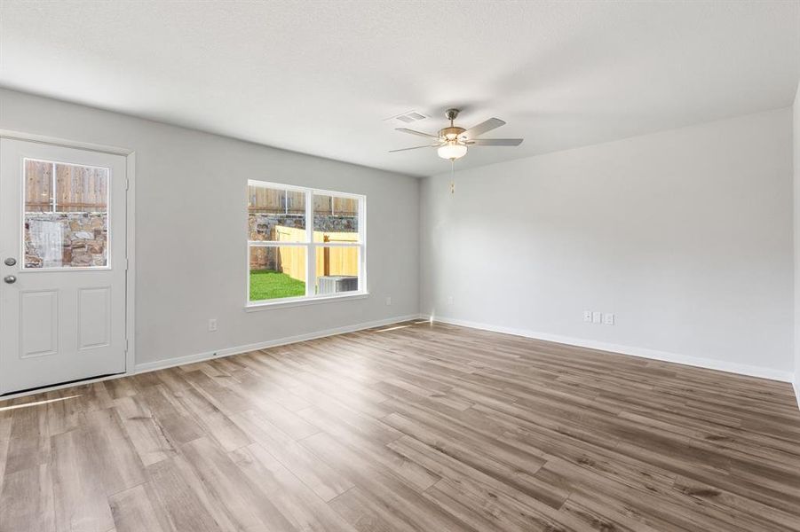 Unfurnished room with ceiling fan and light hardwood / wood-style flooring