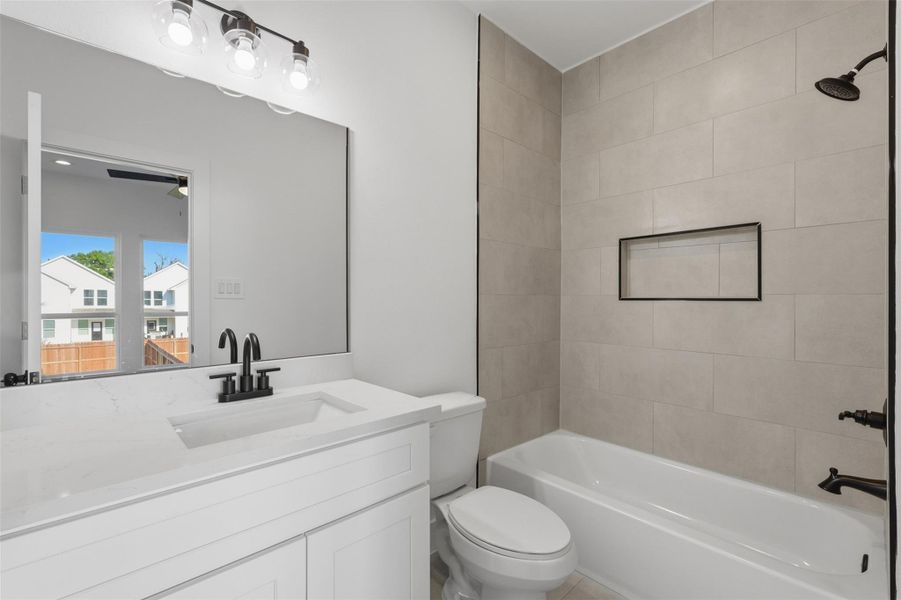 Secondary ensuite bathroom with a tub/shower combo and modern fixtures.