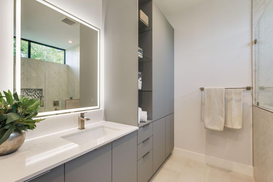 In the extra bathroom, you'll discover abundant space for your daily preparations, adorned with sophisticated accents.