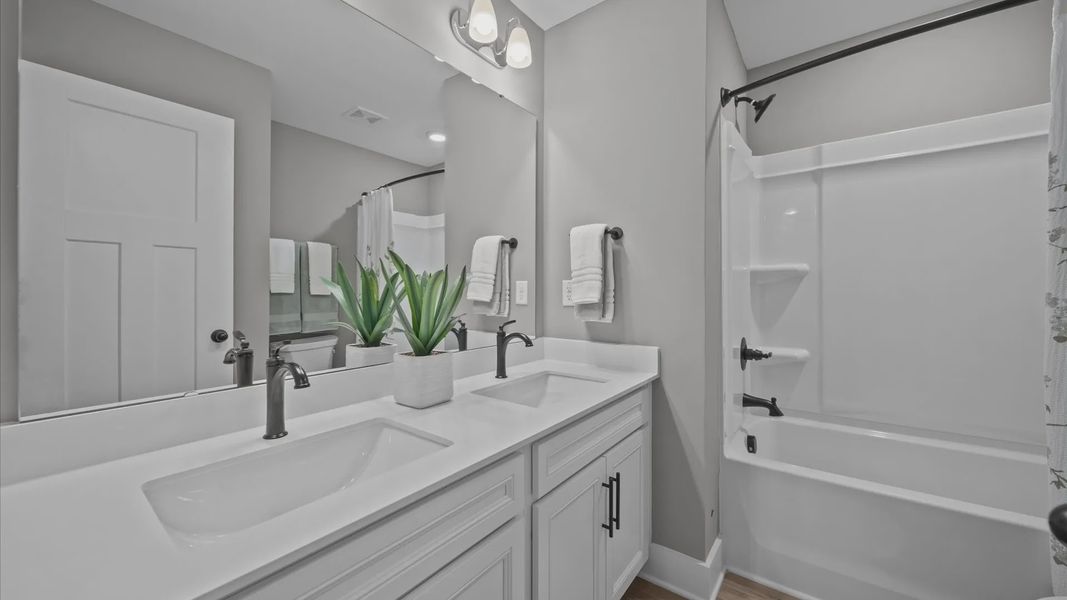 Tasteful bath with modern finishes and thoughtful double vanity layout