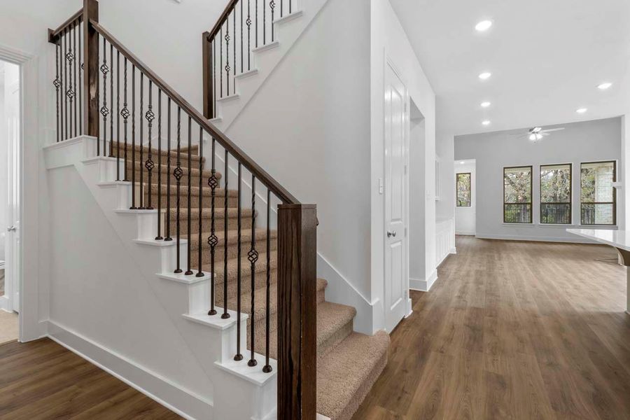 Stairs featuring wood finished floors, recessed lighting, and a ceiling fan Stairs featuring wood finished floors, recessed lighting, and a ceiling fan