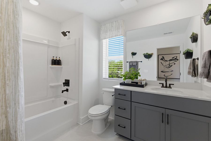 A bathroom with a tub toilet and sink.