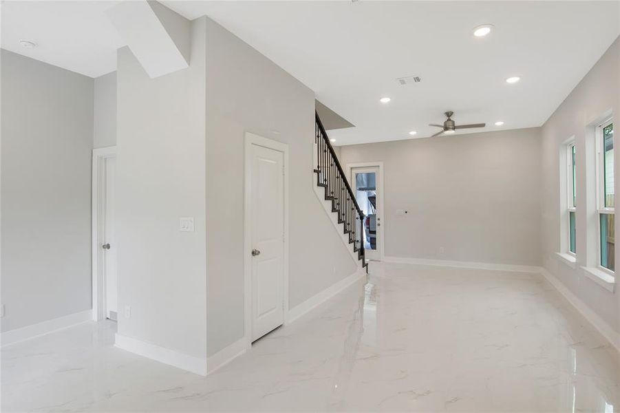 Another view of the living room from the kitchen, door to the far right is to the garage, door in the middle is to the 1/2 bath and the door to the far left is to the primary bedroom!