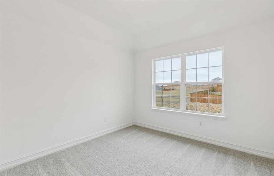 Comfortable secondary bedroom with generous closet space  *Real home pictured